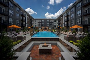 an outdoor courtyard with a pool and an apartment building at Madison Park, Columbus, OH, 43214